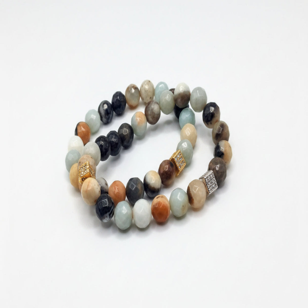Stack of multicolored beaded bracelets on a white background